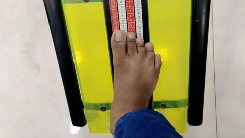 A young boy is checking his feet size in shoe sizes chart concept HD(4k) Video stock 221735258
