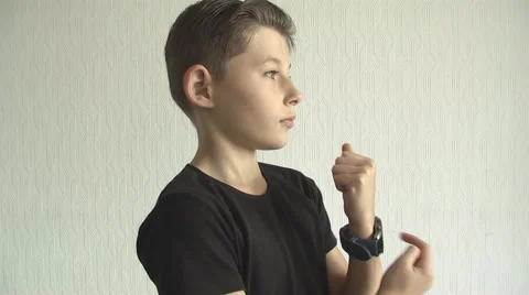 Young boy checking his  for the time on his wrist watch. Stock Footage 68431841