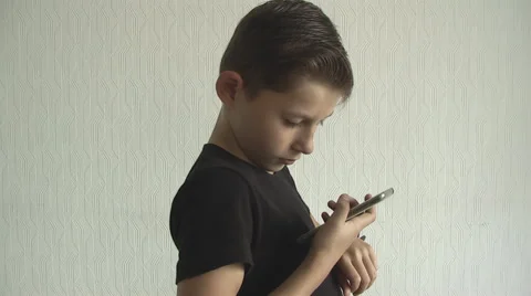 Young boy checking his  for the time on his wrist watch. Stock Footage 68434637