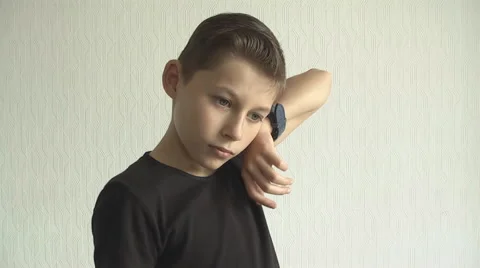 Young boy checking his  for the time on his wrist watch. Stock Footage 68439358