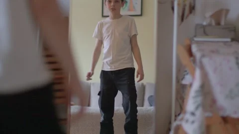 Young Boy Checking Reflection in the Mirror at Home Stock Footage 316490088