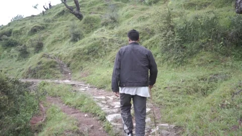 A young boy climbing the mountain with a backpack. Trekking and adventure. Stock Footage 147091207