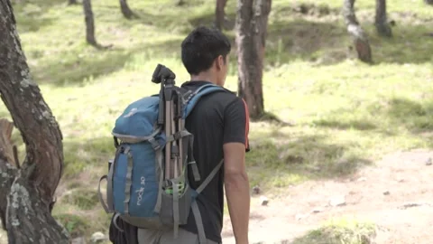 A young boy climbing the mountain with a backpack. Trekking and adventure. Stock-Footage 147091287
