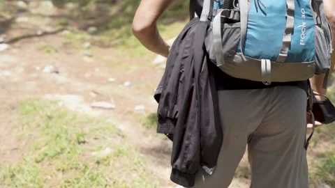 A young boy climbing the mountain with a backpack. Trekking and adventure. Stock Footage 147091420