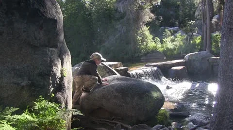 Young boy climbing on rock Stock Footage 25590663