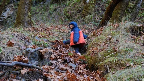 Young boy climbing a steep mountain slope. Stock Footage 121353239