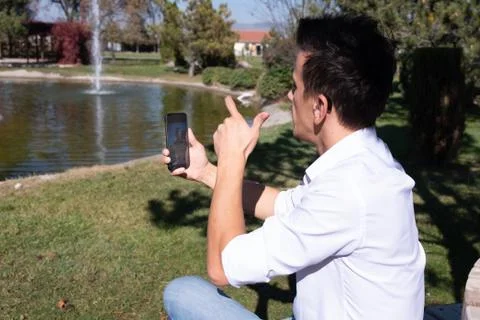 Young boy communicating with sign language  at smart phone Stock Photos