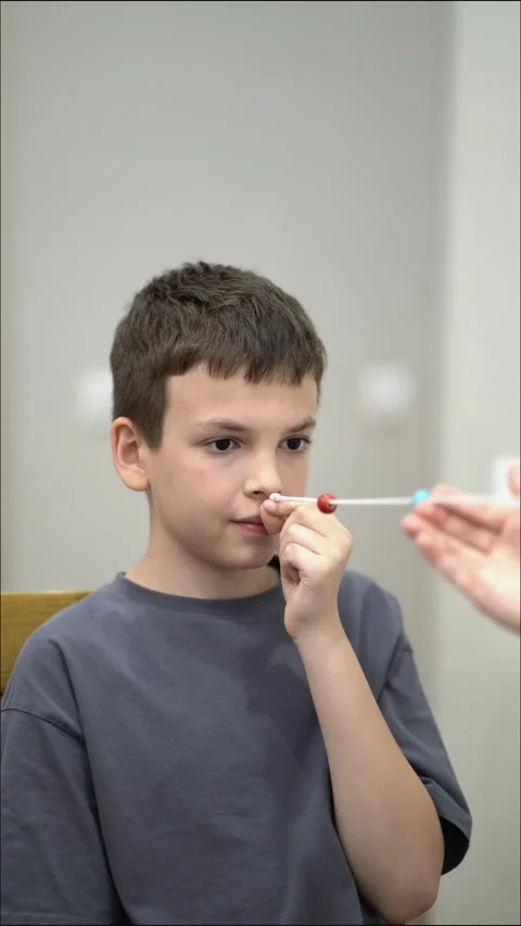 Young boy concentrates on beads of a Brock string held by his mother Video stock 342192845