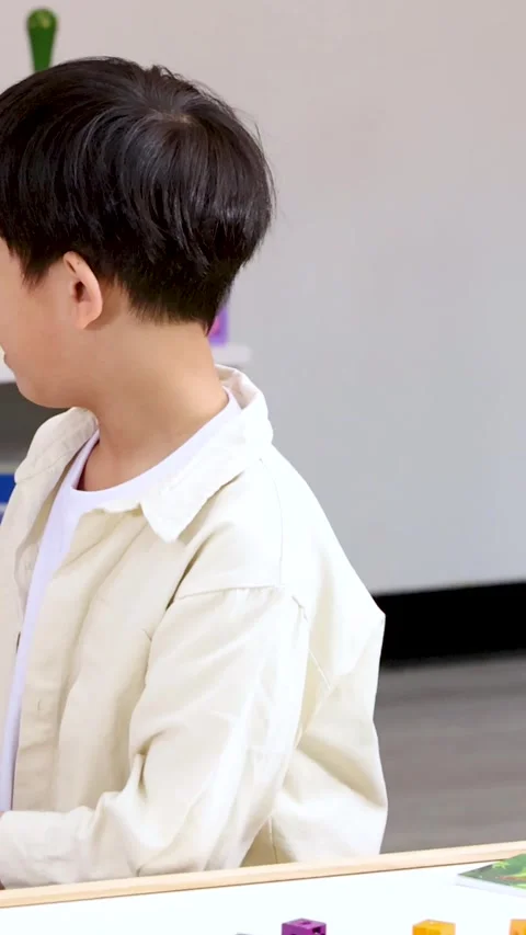 Young Boy Concentrating on Math Lesson with Colorful Counting Blocks Stock Footage 329466070
