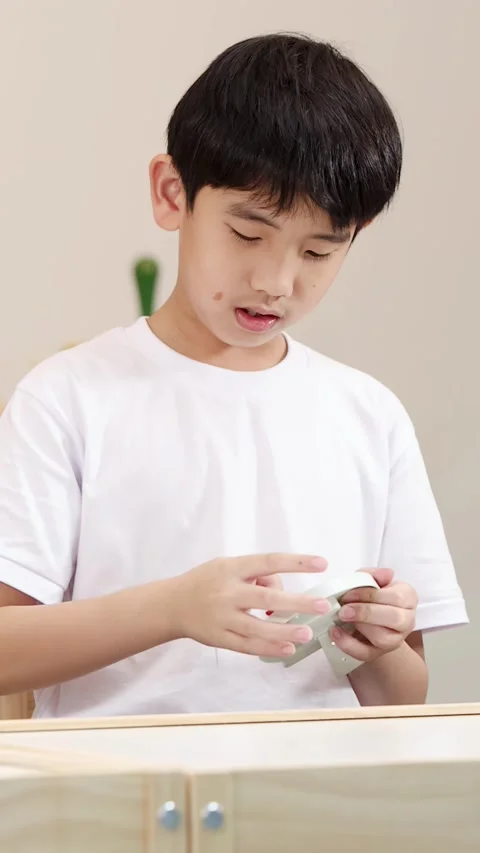 Young Boy Concentrating While Exploring Educational STEM Learning Tools Stock Footage 326386746