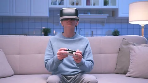Young Boy with Console Controller and VR Headset Playing Game in Virtual Reality Stock Footage 233507721