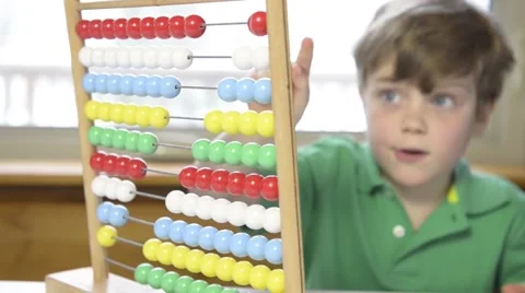 Young boy counting with abacus Stock Footage 43965358