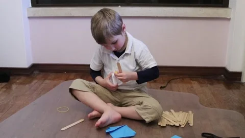 Young boy creating diy craft project at home Stock Footage 327407808