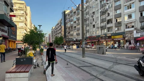 Young boy crossing tram way while scooters riding by Stock Footage 230453073