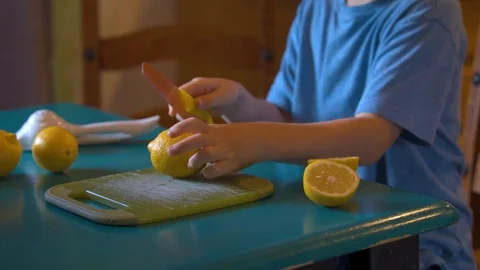 Young Boy Cutting Lemons for Lemonade Stock Footage 94395099