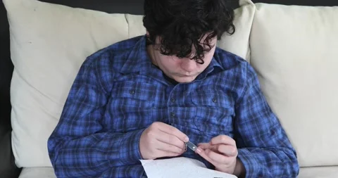 Young boy cutting nails using nail clipper Stock Footage 147598937