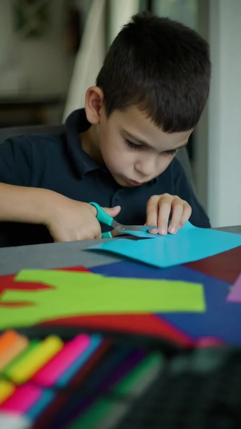 Young Boy Cutting Paper With Scissors Video stock 343451556