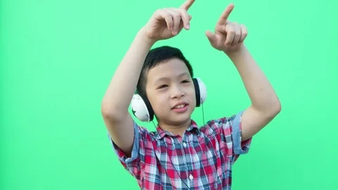 Young boy dancing in front of green screen Stock Footage 89261276