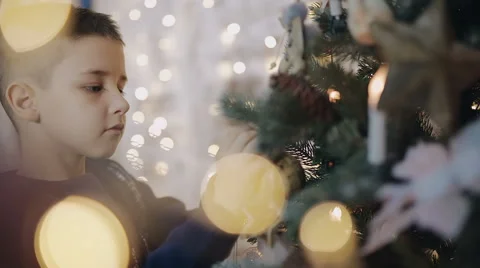 Young boy decorates a Christmas tree Stock-Footage 57224946