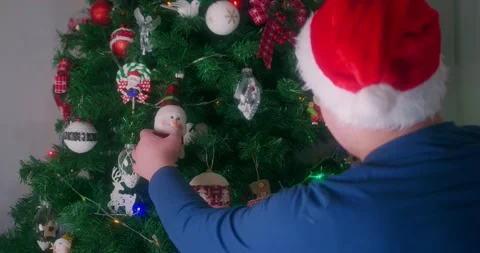 Young Boy Decorating a bright and colorful Christmas Tree Stock Footage 144580538