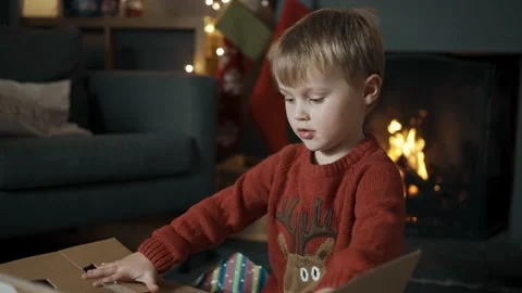 A young boy delighted by his present on Christmas. Stock Footage 143160283