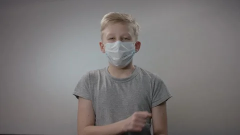 Young boy is demonstrating one of the ways of preventing Corona Virus infection Stock Footage 128654604