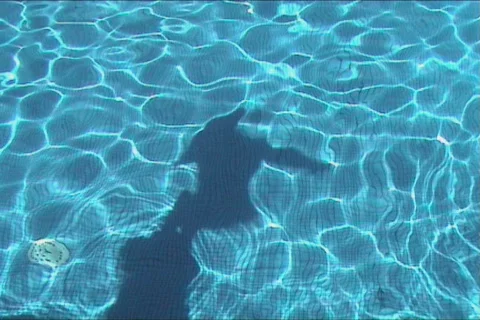 Young boy diving in the swimming pool Stock Footage 101173