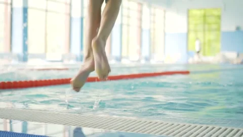 Young boy diving into the swimming pool. Child jumps into the water Stock Footage 157727754