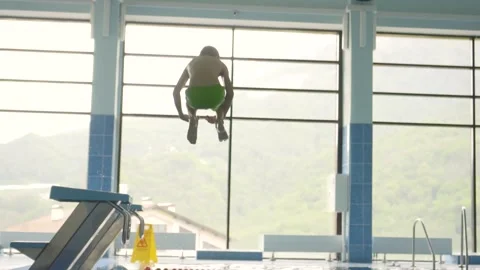 Young boy diving into the swimming pool. Child jumps into the water Stock Footage 157730652