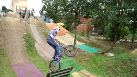 Young boy doing 360° TRICK Purple BMX dirt Jump (120FPS) Stock Footage 128927698