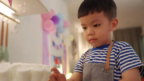 Young boy doing cake in a kitchen Stock Footage 293118478