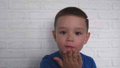Young boy doing faces in front of white background. Stock Footage 165102141