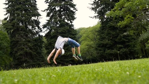 Young boy doing flips on nature day Stock Footage 112018682