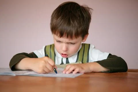Young boy doing his homework at home Stock Photos