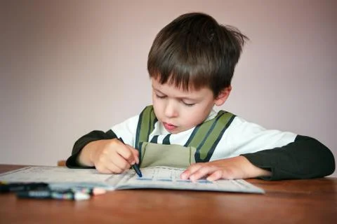 Young boy doing his homework at home Stock Photos
