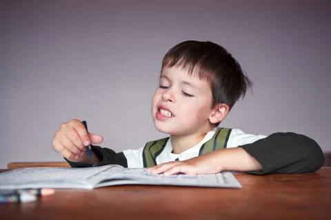 Young boy doing his homework at home Stock Photos