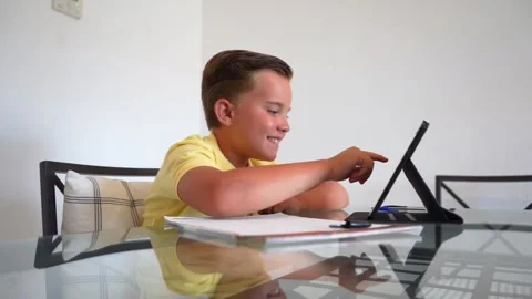 Young boy doing homework at home 動画素材 136610201