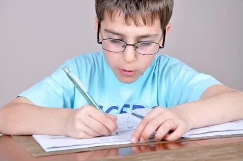 Young boy doing homework Stock Photos
