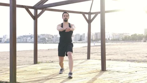 Young boy doing physical exercise at the beach Stock Footage 131006720