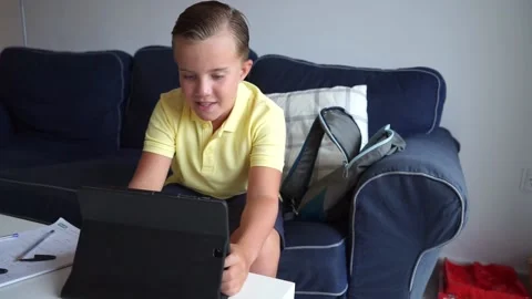 Young boy doing schoolwork at home 動画素材 136610188