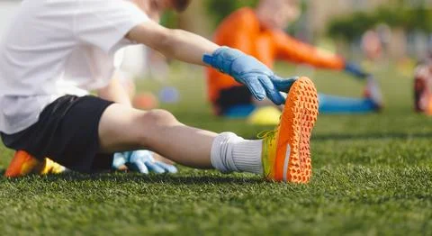 Young Boy Doing Soccer Stretching Exercises. Kids in Football Goalkeepers Stock Photos