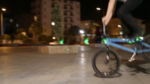  A young boy doing stunts on sport bike BMX Stock Footage 62754314