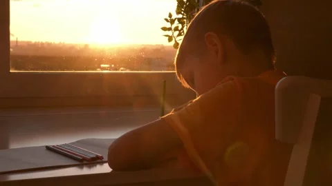Young boy drawing with colored pencils at sunset Video stock 325084014