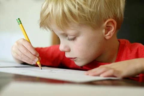 Young boy drawing with pencil Stock Photos