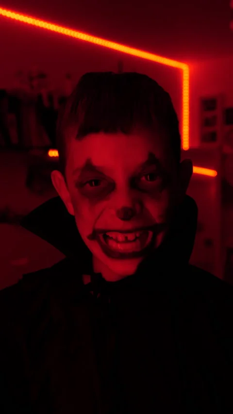 Young boy dressed in black and looking scary, halloween time, vertical video Stock Footage 219274632