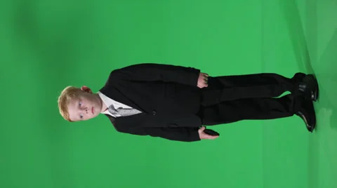 A young boy dressed for business talking on a cell phone, hysterical! Stock-Footage 39484576