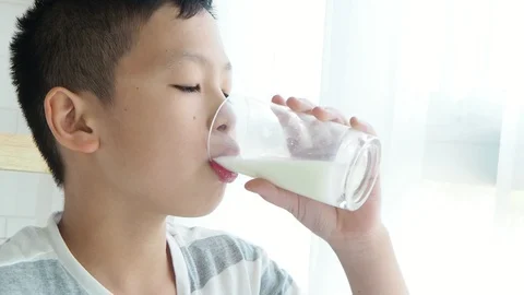Young boy drinking a glass of milk Stock Footage 88897902