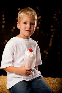 Young boy drinking milkshake Stock Photos