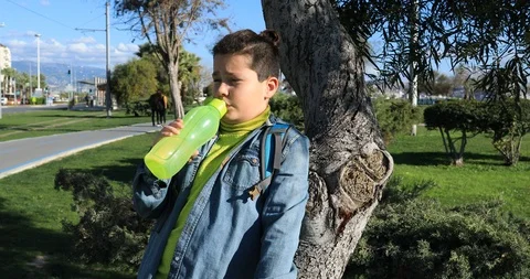 Young boy drinking water at the outdoor Stock Footage 87679461