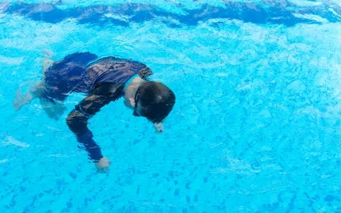 Young boy drowning in the pool Stock Photos
